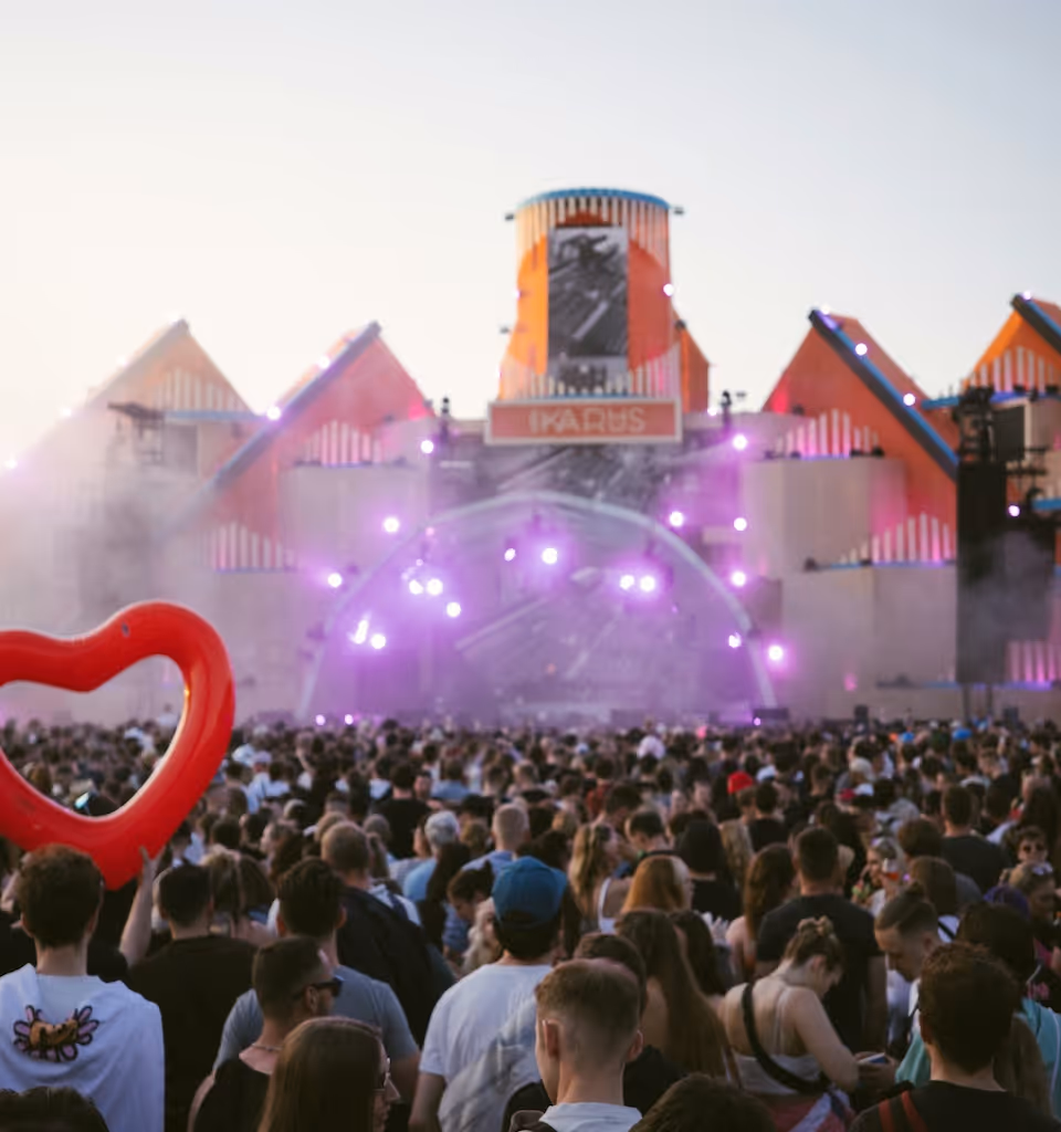 Crowd at an outdoor music festival with stage