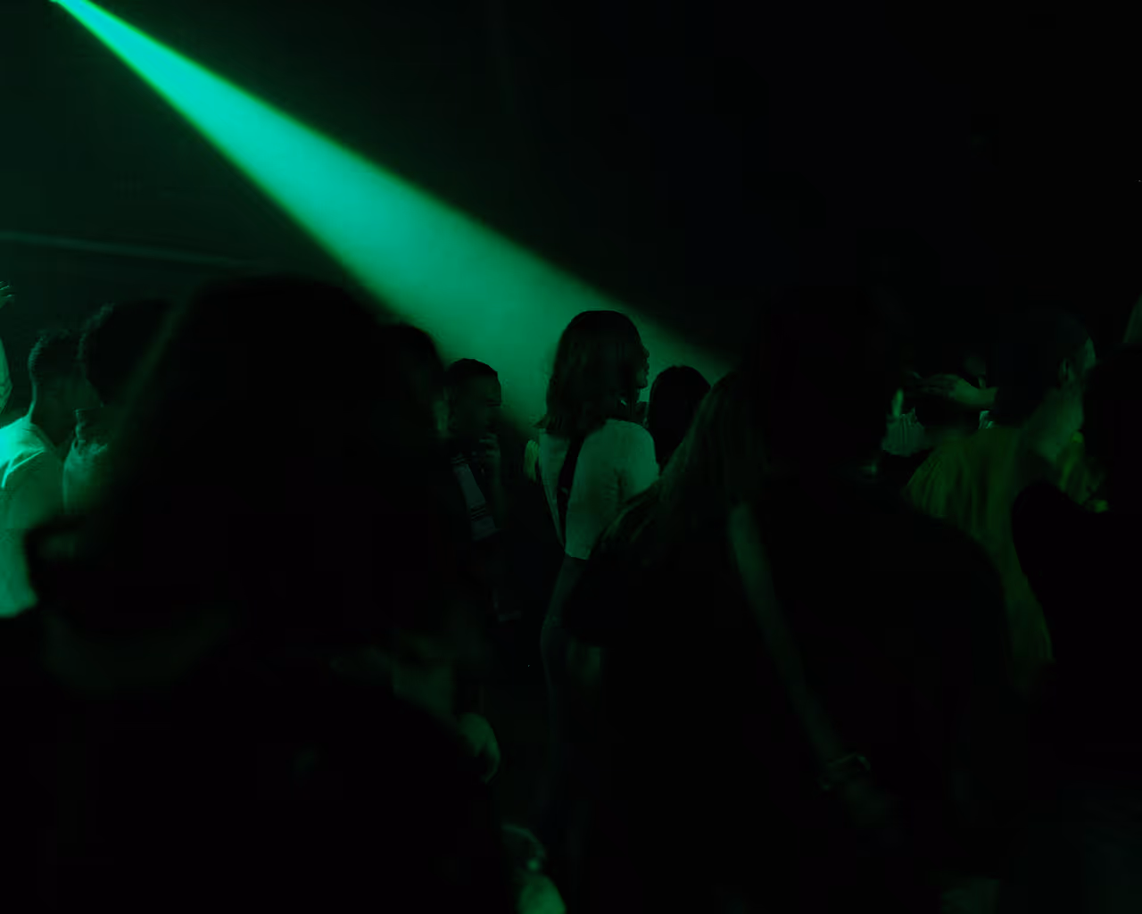 Dancers under green lights